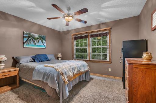 The primary bedroom offers the convenience of double closets and comfy carpet flooring.