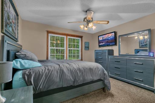 Both upper-level bedrooms feature ceiling fans.