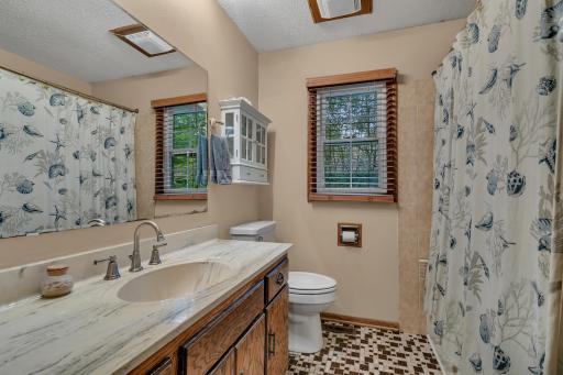 The full bathroom provides a spacious vanity and linen cabinet, complemented by an additional hallway linen closet for plenty of storage.