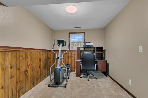 Here is a side nook in the family room that might work as an office space or play area for the kids. There is storage space beneath the stairs and in the foyer to help keep everyday life organized.