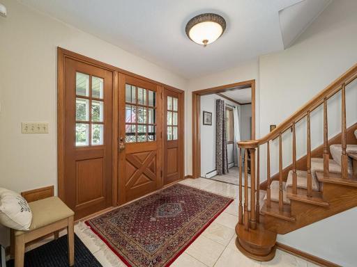 Spacious and open front foyer features tile floor with wooden staircase welcomes you to this lovely home.