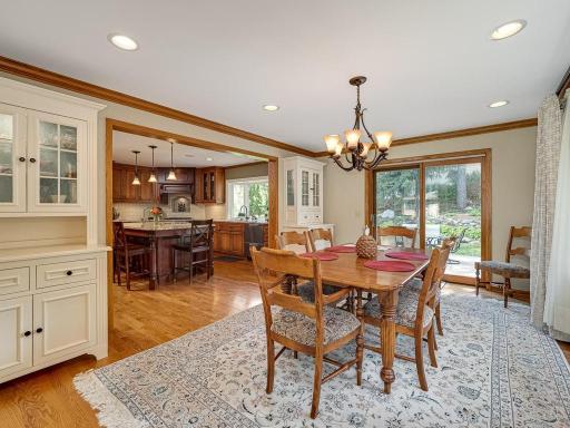 Very spacious formal dining room features hard wood flooring under rug, two beautiful back-lit custom built-ins!