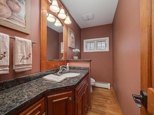 Updated 1/2 bath with granite counter conveniently located between mudroom and kitchen.