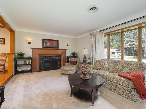 Living room features wall of north facing windows to let in the natural light. Gas fireplace.