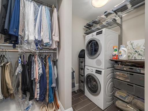 2nd walk-in closet outside Owners Suite bathroom has Bosch stackable washer/dryer plus closet organizers .The beautiful tile floor extends in private Owners Suite bathroom.