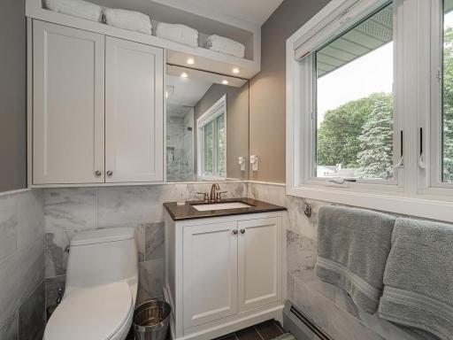 In 2022 the Owners Suite bathroom beautifully updated. Note the custom tiles on the walls.