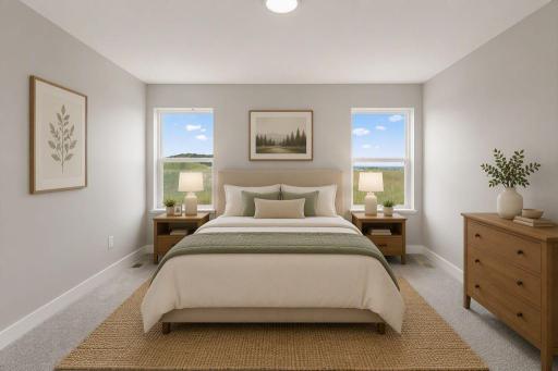 The primary bedroom suite includes a private bathroom and a spacious walk-in closet. Photo of model home, colors and finishes vary.