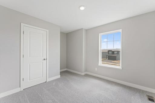 One of the three secondary bedrooms. Colors and finishes may vary.