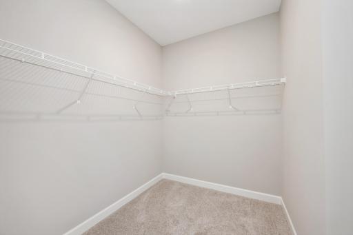 Primary suite walk-in closet - photos are of a completed inventory home of the same floorplan. Colors and selections may differ.
