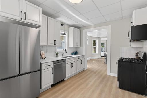 Main level kitchen with new SS appliances, cabinets, countertops and LVP flooring