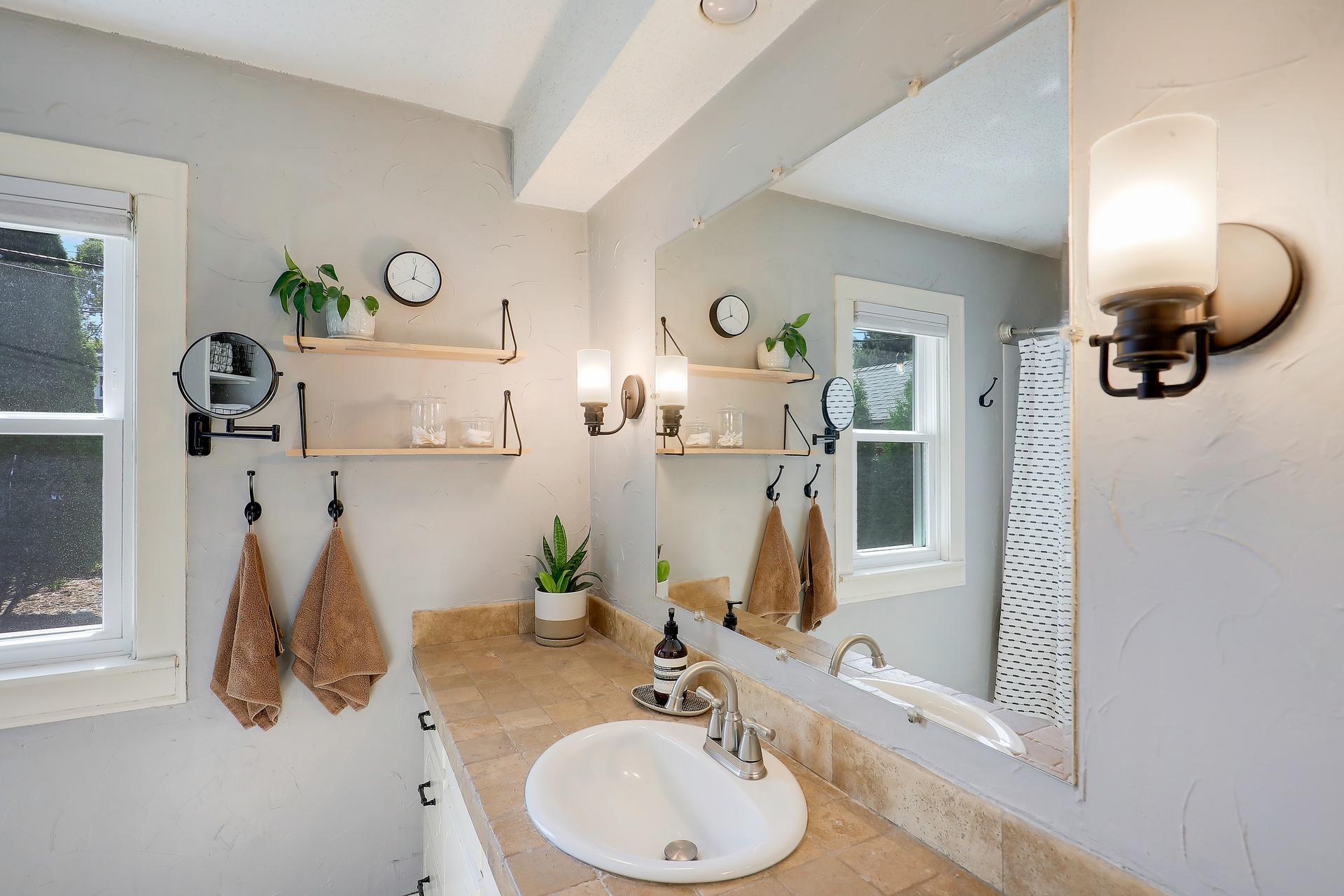 The full bath has a long vanity with storage cabinets.