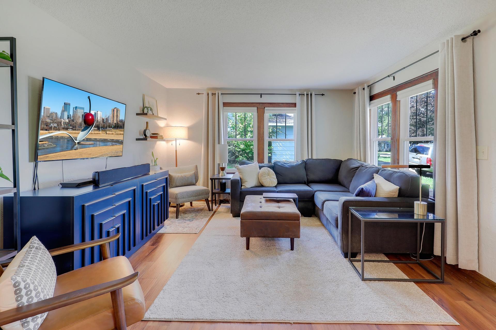 Open living area with wood flooring has plenty of natural light.