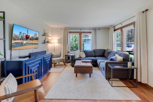 Open living area with wood flooring has plenty of natural light.