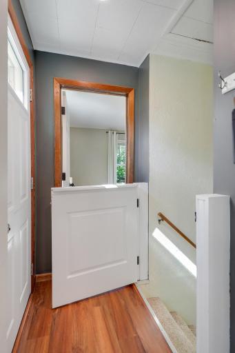Custom half door allows protection for toddlers and pet without closing off the lower level.