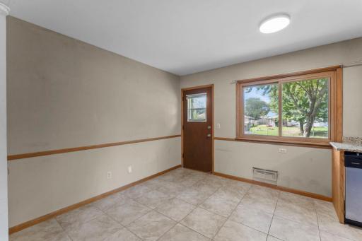 Eat In Kitchen Area With Door to the Rear of the Home