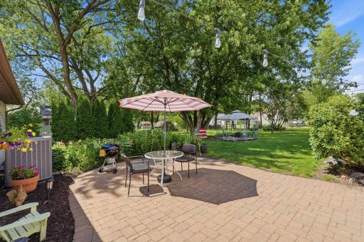 Large Paver Patio surrounded by Beautiful Gardens
