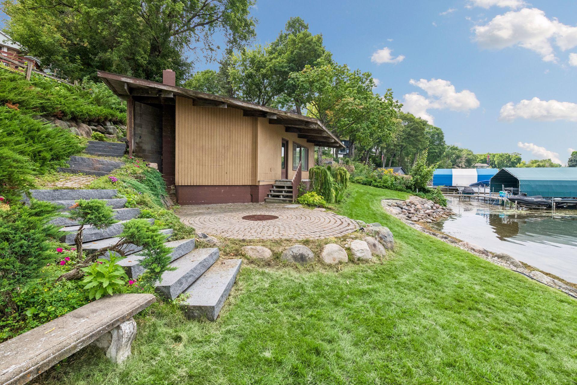 Fire pit and paver patio just steps from the water’s edge.