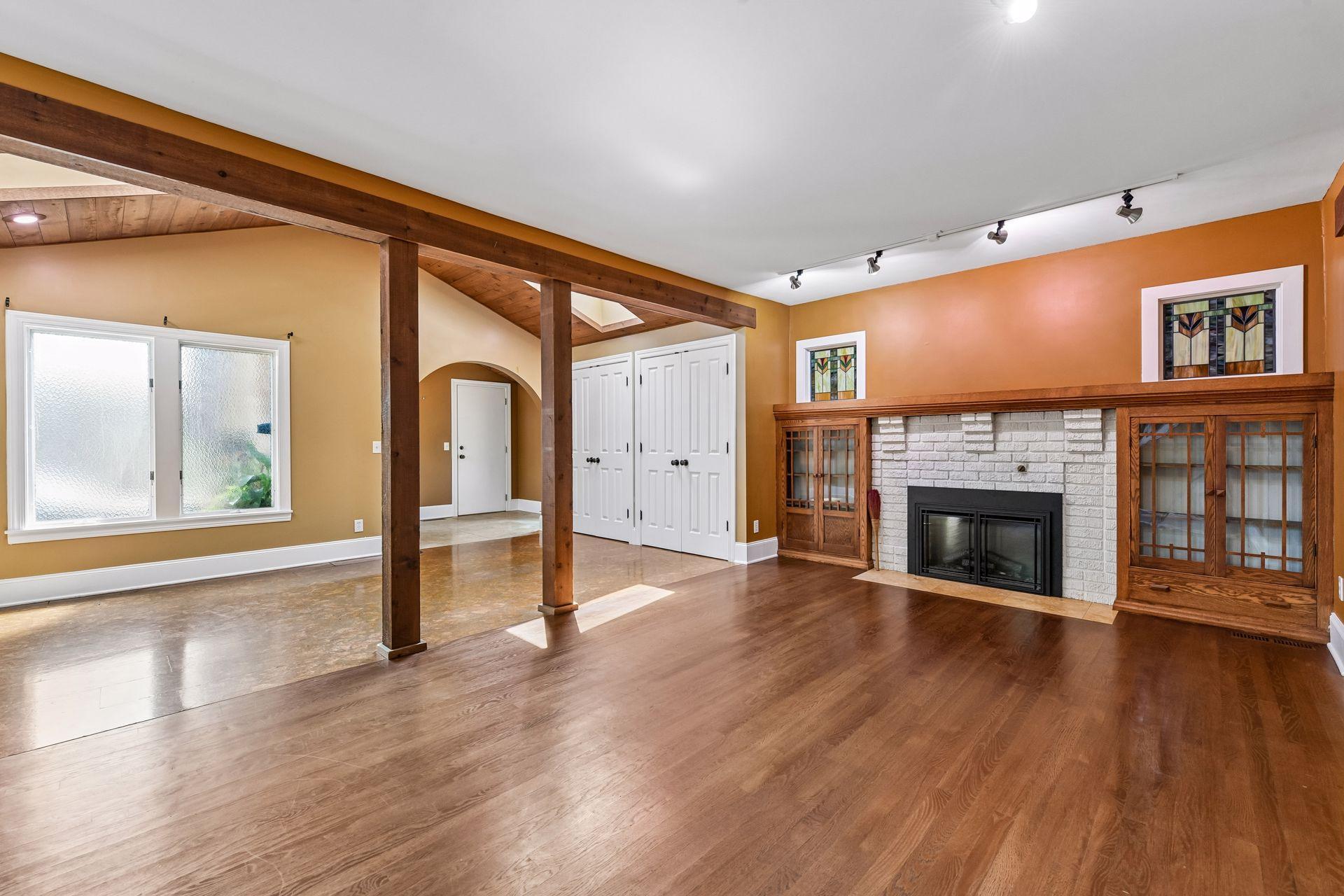 Welcoming foyer and living room with gas fireplace and skylights.