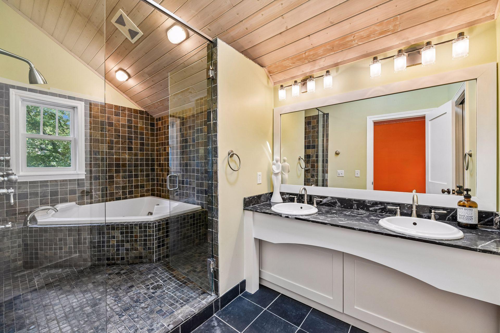 Spacious primary bath with dual vanities and walk-in shower.