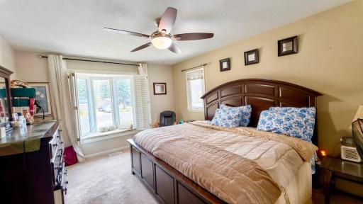 Serene primary bedroom with rich wood furnishings