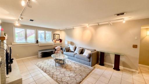 Comfortable family room with plush seating and warm track lighting. Made for movie marathons.