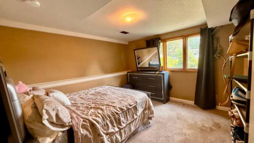 Comfortable bedroom with warm tones and natural light.