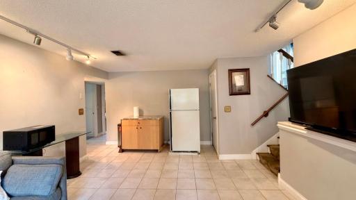 Lower level hallway with staircase access, smart flow between levels.