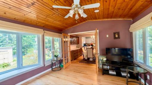 Sun-filled sunroom flows right into the next room