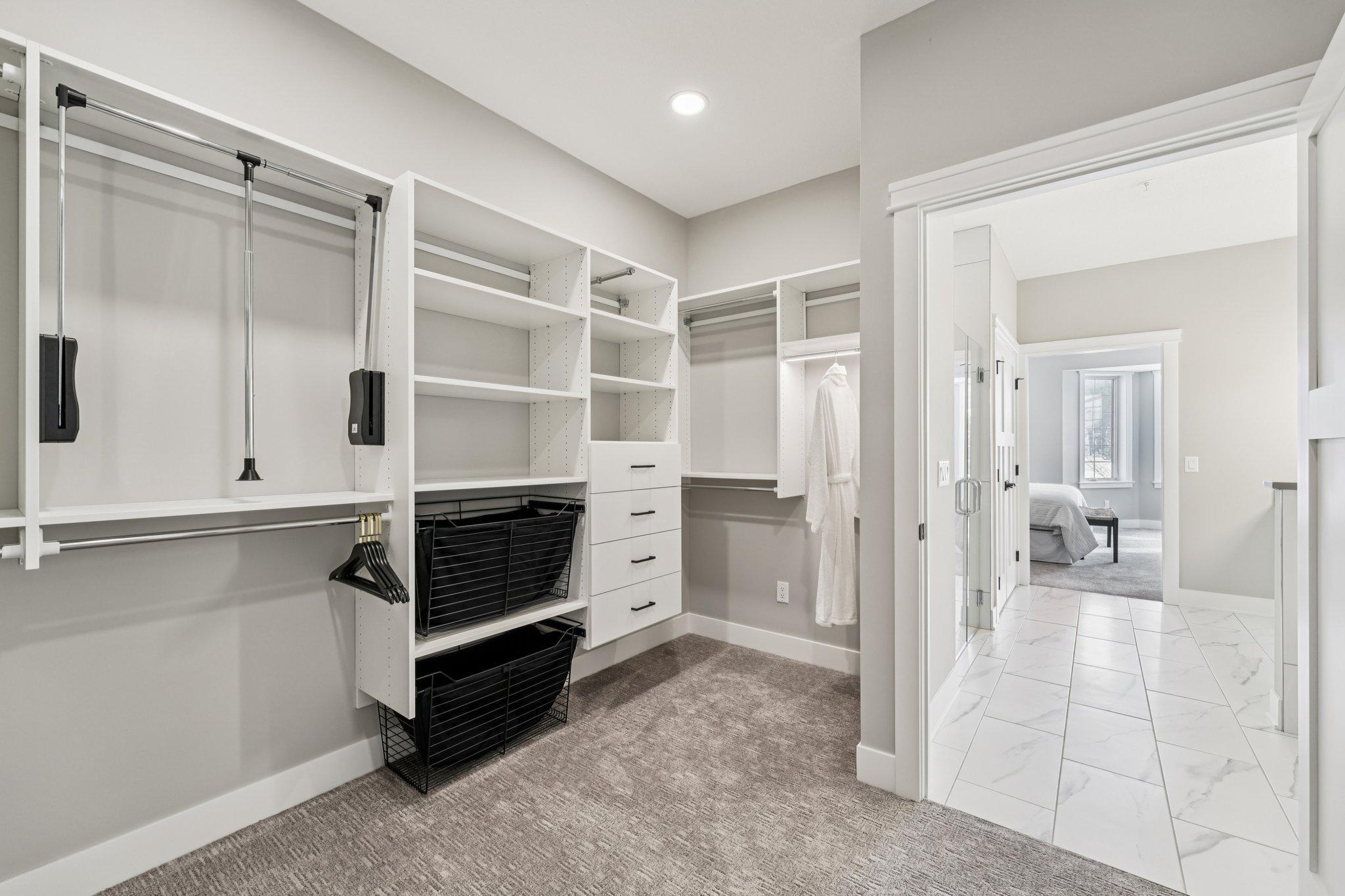 Spacious walk-in closet with custom shelving, drawers, and hanging space—designed for organization and convenience.