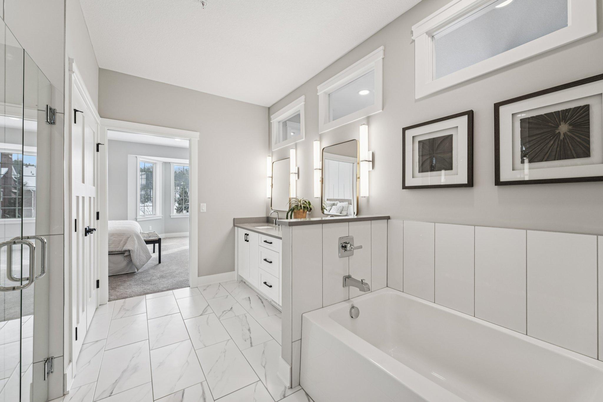 Relaxing soaking tub surrounded by elegant tilework and soft lighting—ideal for unwinding at the end of the day.