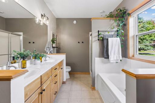 Primary ensuite bath with double sinks and separate shower and tub.