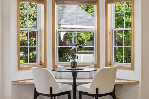 Banquet seating graces the stunning bay window in the kitchen, and overlooks the big yard with a gazebo.