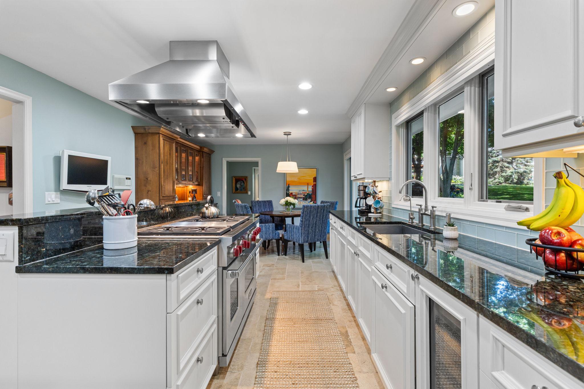 Designed for those who love to cook and entertain, it features stainless steel appliances including a high-end Wolf range.