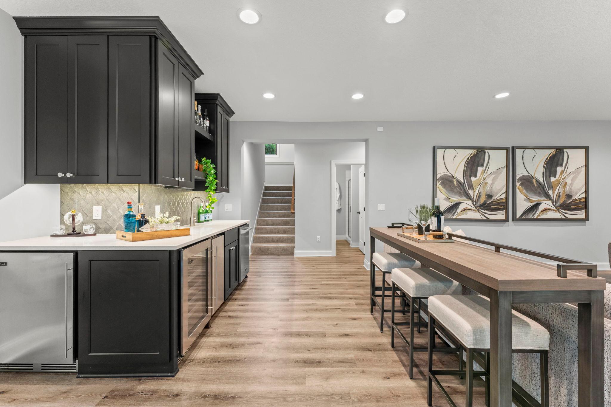 Wet bar features mini-fridge, wine fridge, ice maker and dishwasher