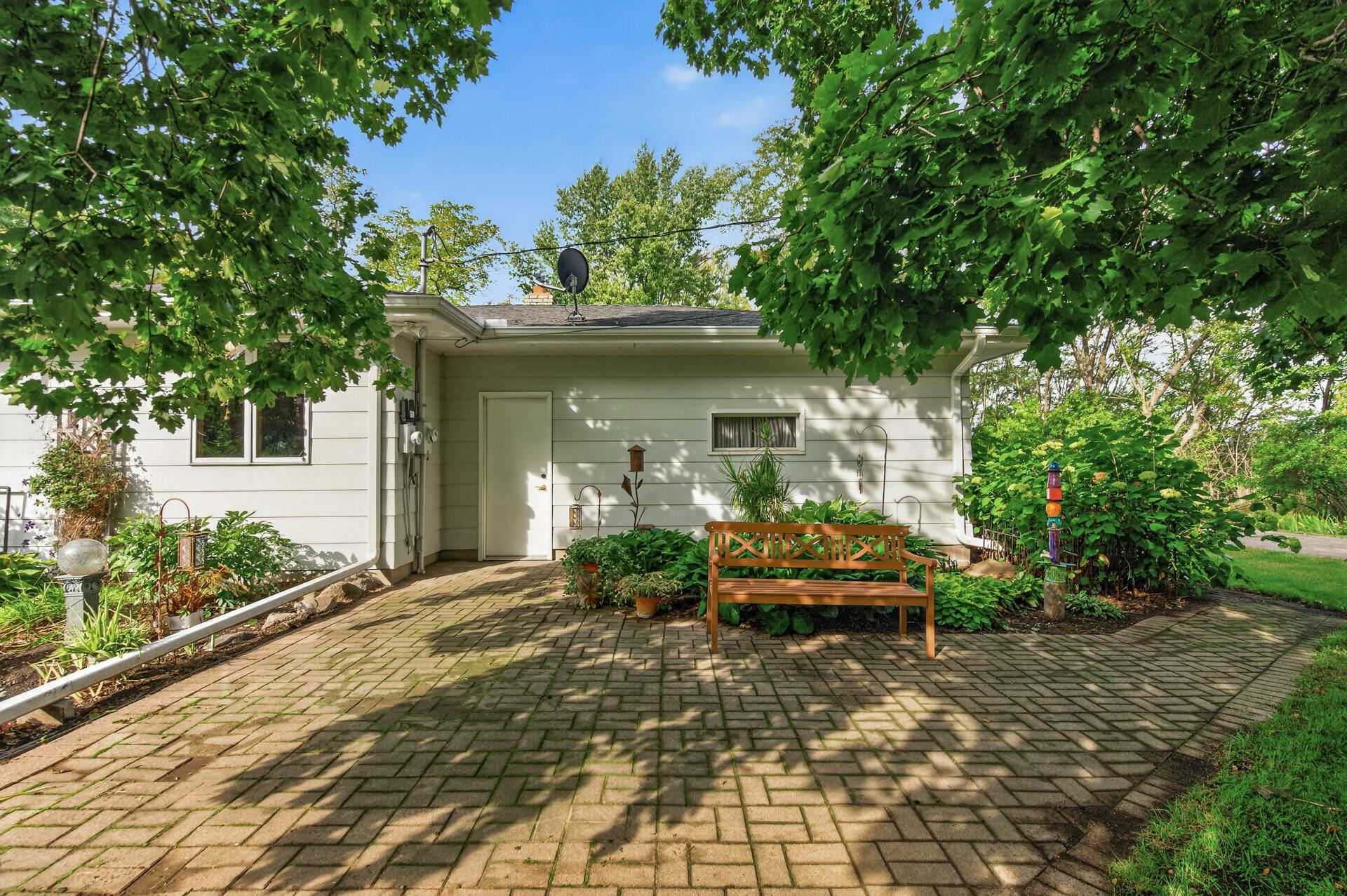 Spacious patio surrounded by flowers and plants!