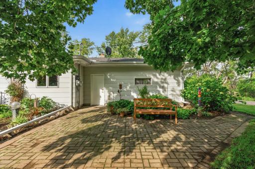 Spacious patio surrounded by flowers and plants!
