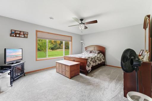 Wake up to nature in the expansive primary suite, where the bedroom offers stunning, unobstructed views of the peaceful forest just beyond your backyard.