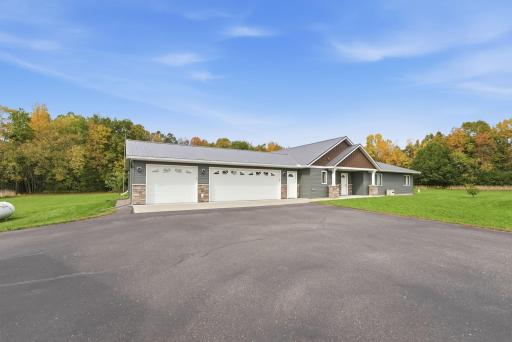 Premium asphalt driveway boasts a massive turnaround bay, offering unrivaled parking capacity and a perfect, smooth surface for recreation.