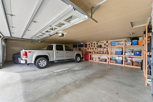 Impressive, fully insulated and sheet-rocked 3-car attached garage! Features built-in shelving, convenient floor drains, and an exterior connection ready for a whole-house generator.