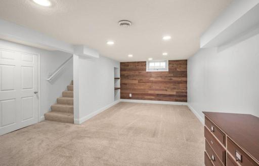 The finished basement adds room to spread out, with recessed lighting and a wood accent wall creating a welcoming space for game nights, a home gym, or your favorite hobbies.
