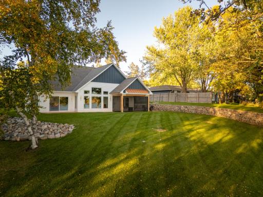 Nestled on a beautifully landscaped lot with lake Latoka stone retaining walls and a smooth gradual slope that guides you directly down to your private lakefront shoreline.