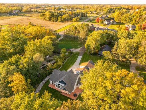 Stunning aerial views highlight this Exceptional single-family custom-designed lake home. Perfectly nestled with nature, showcasing manicured lawns and vibrant trees.