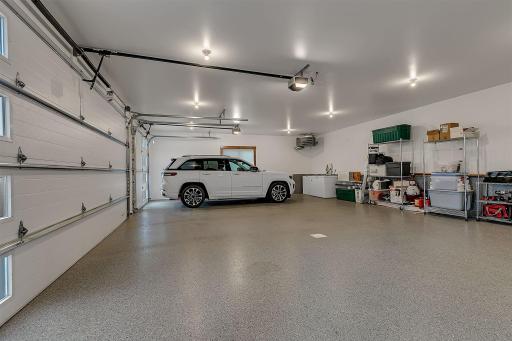 Spacious and pristine attached garage, expansive space accommodates multiple large vehicles, plenty of room left over for storage racks. *38FT wide by 26FT deep, completedly finished, heated, insulated garage doors, apoxy finish, 2 floor drains.