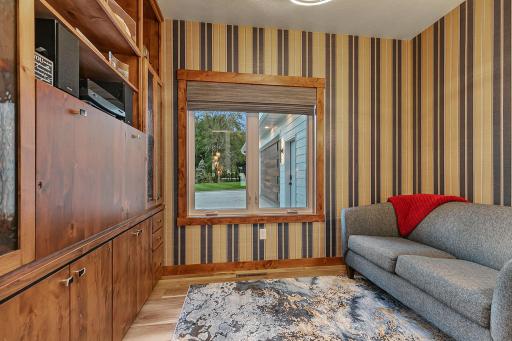 Office-Den-Study-Sophisticated atmosphere with full wall custom cabinets, pocket door for privacy.