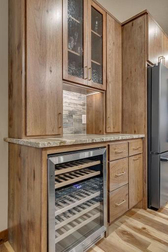 Wine/beverage center with rain glass cabinets to display glassware, recycle drawer for convience.