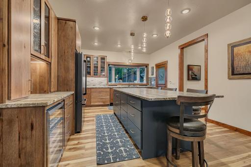 Kitchen with 9FT ceiling, Hickory cabinets with a warm tone stain, nautical blue island with deep drawers, spice drawer and custom hidden mixer stand.