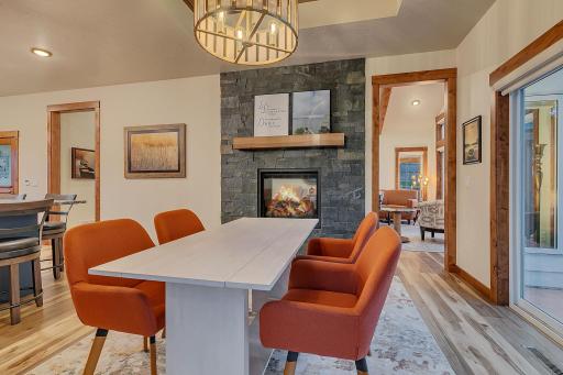 Dining area features 2 sided fireplace and entrance to living room and easy access to the outdoor lakeside patio.