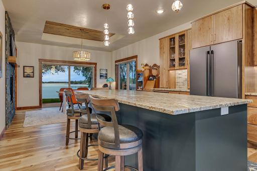 GE Cafe refrigerator, ice maker in the lower freezer, custom black handles which then matches range hood accent. Island with overhang for 6 bar stools.