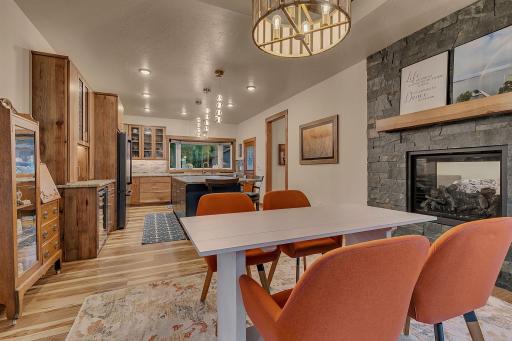 Open kitchen and dining area with 2 sided fireplace and designed for easy entertaining.