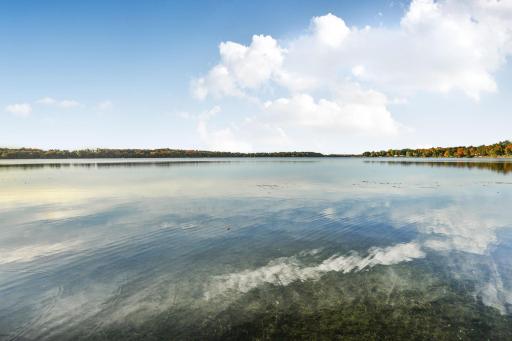 This exceptional property offers direct, crystal-clear water access where you can swim directly from the shoreline or take a short stroll to enjoy the vibrant public beach.
